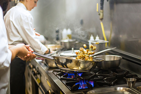 Chef preparing cuisine in hotel kitchen