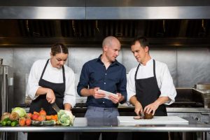 Restaurant manager works with his professional chef's